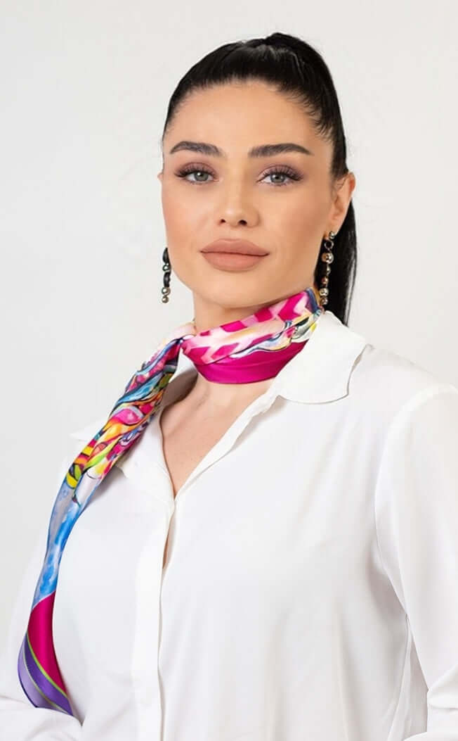 Woman wearing a fuchsia designer silk scarf, showcasing a bold and stylish accessory.