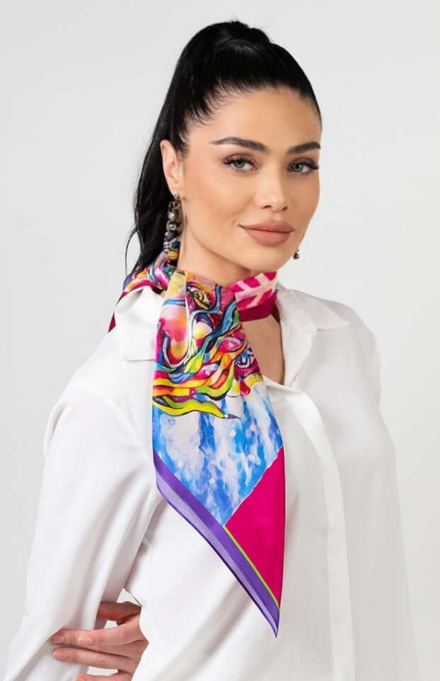 Woman wearing Designer Silk Scarf 'Power' in fuchsia, symbolizing strength and freedom, tied stylishly around her neck.