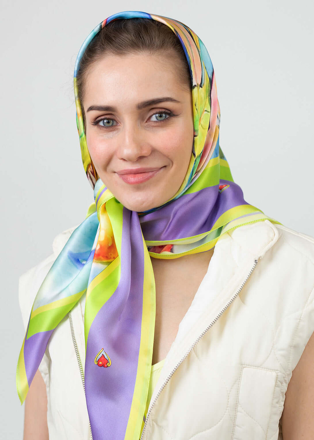 Model wearing a Designer Silk Scarf Summer Garden Violet, Hearts, displaying vibrant colors and floral patterns.