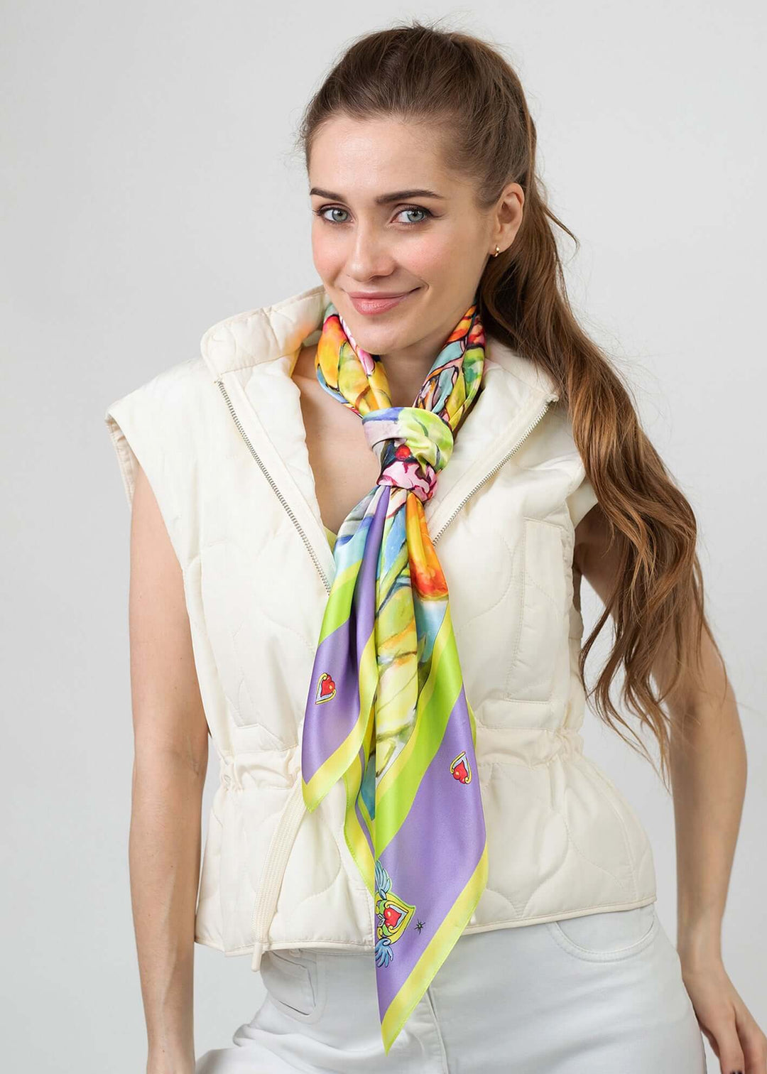 Model wearing Designer Silk Scarf Summer Garden Violet, Hearts styled with a light vest.