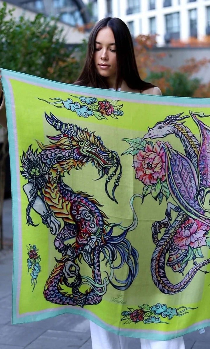 Model showcasing Designer Schal Dragons in yellow cashmere with dragon graphic design, measuring 90x90 cm.