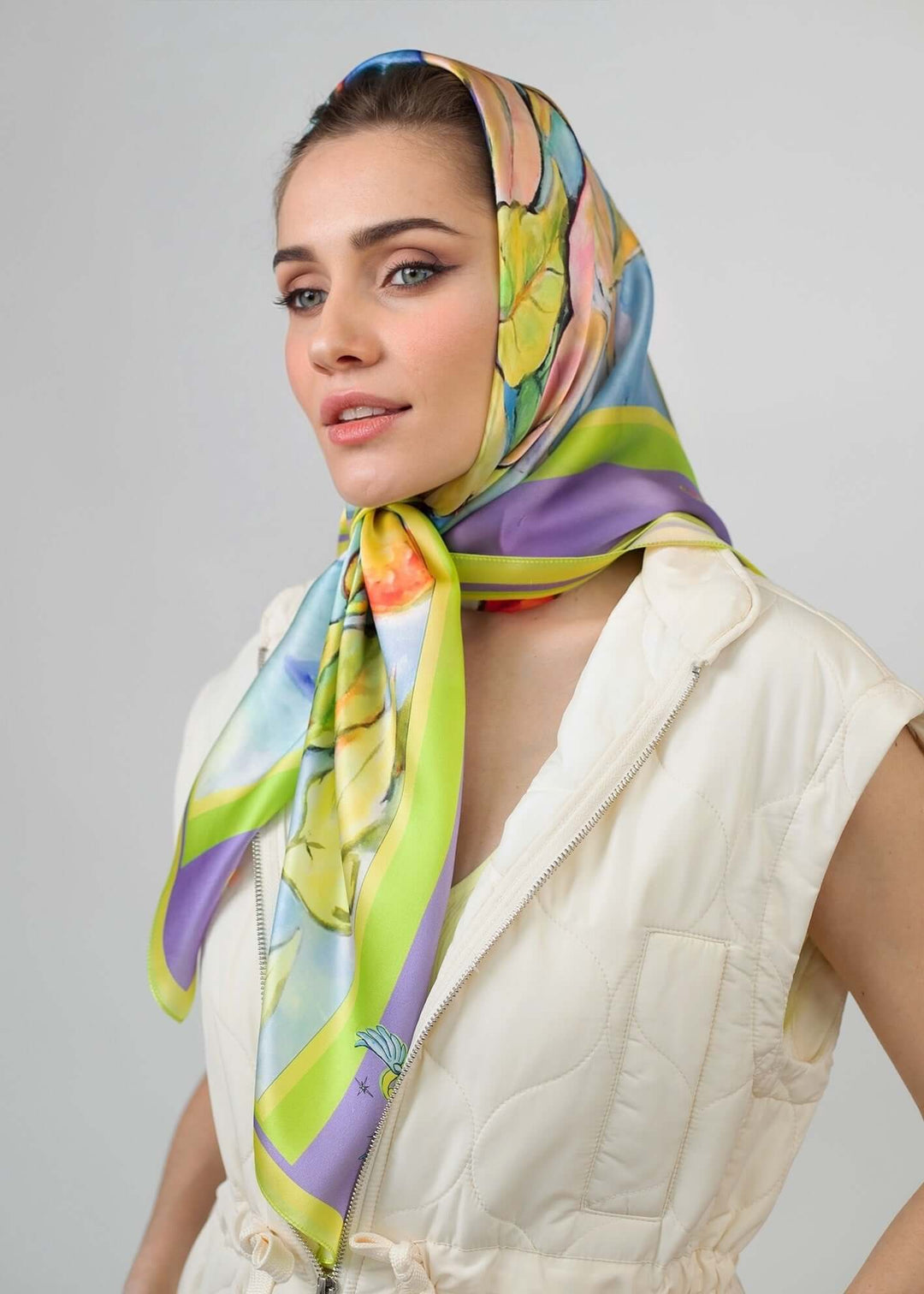 Model wearing a Designer Silk Scarf, Summer Garden Violet, Hearts, showcasing vibrant colors and floral design.