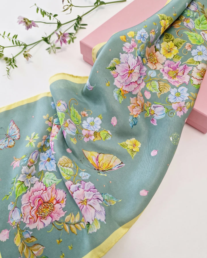 Close-up detail of premium silk twill scarf with floral watercolor pattern