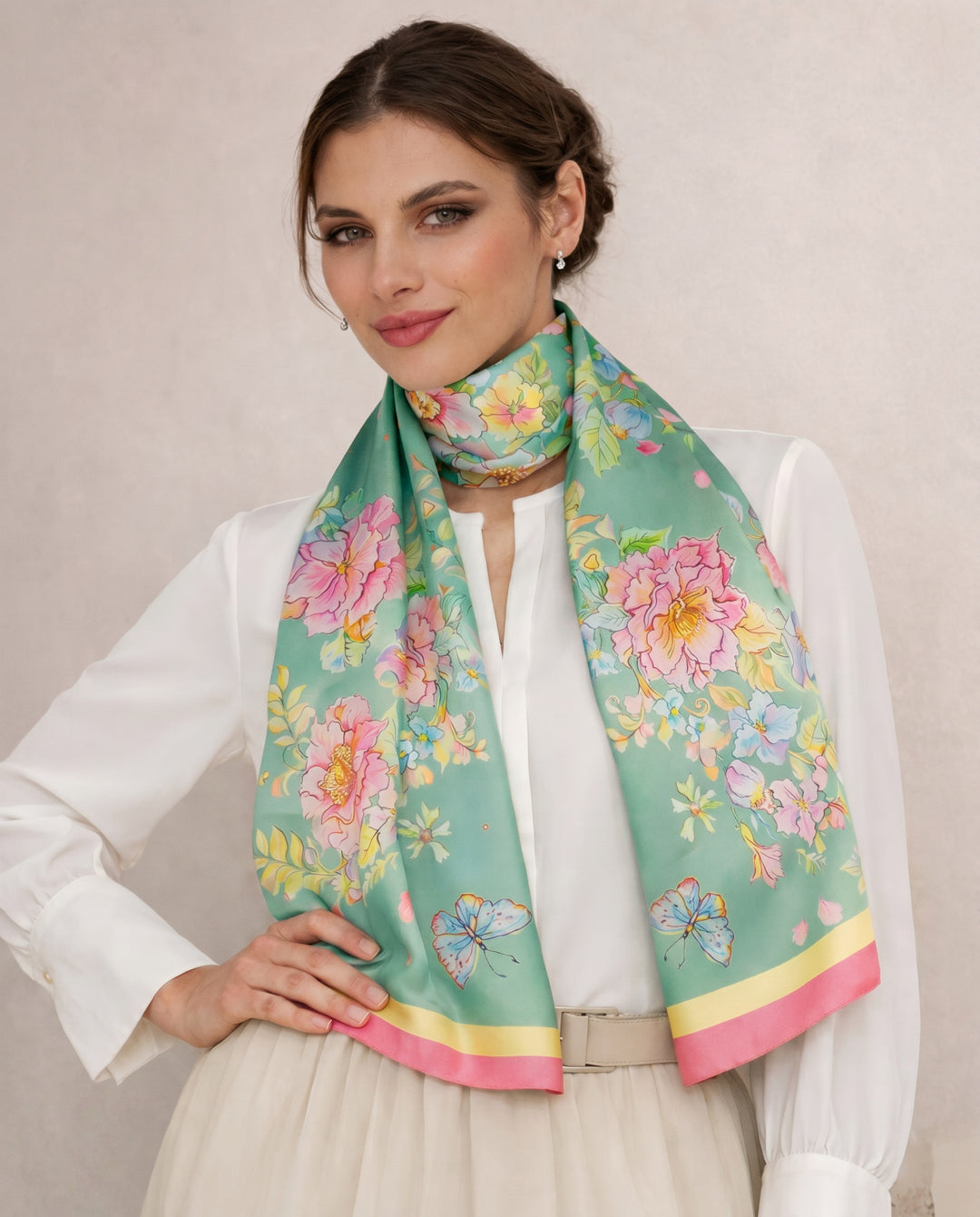Elegant woman wearing a mint green floral silk scarf inspired by watercolor art
