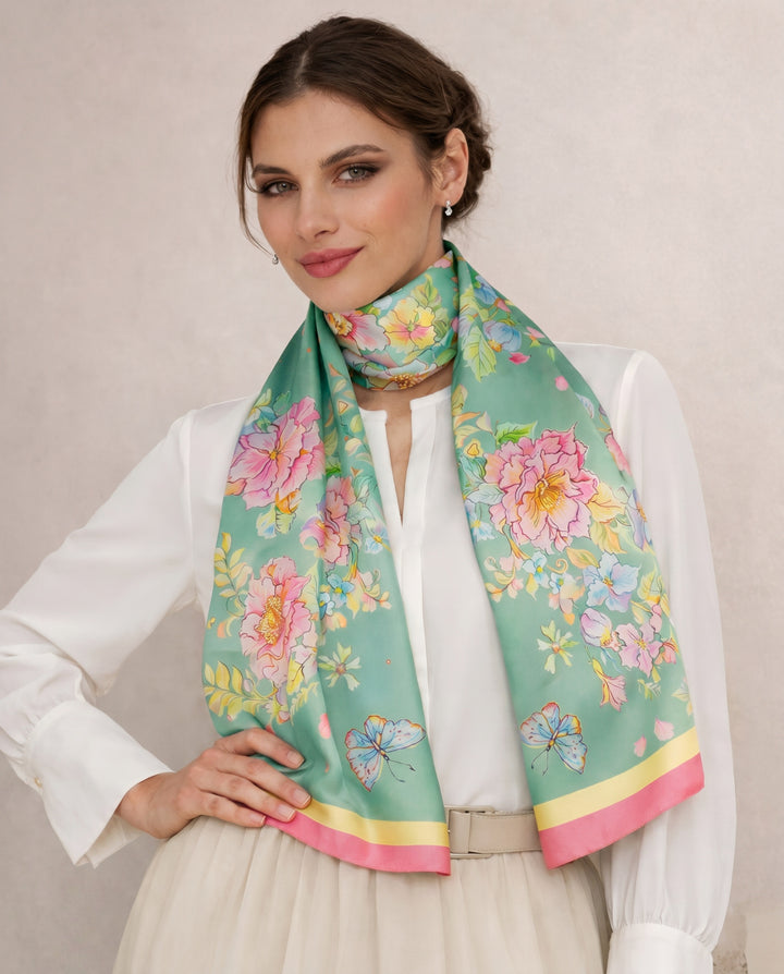 Elegant woman wearing a mint green floral silk scarf inspired by watercolor art